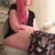 A plump girl with red-dyed hair pushes and grunts while sitting on a toilet. Some very small plops are heard. Presented in 720P HD. Over 3 minutes.